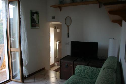 a living room with a couch and a television at Il Nido del Picchio in Ascoli Piceno
