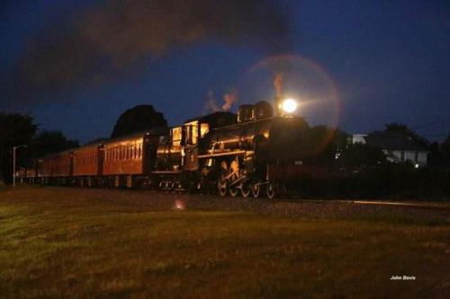 a train is on the tracks at night at Manakau House The Old Manakau Hotel 1920 in Manakau