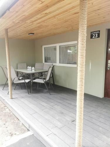 a patio with a table and chairs on it at Domek MajAmi in Turawa