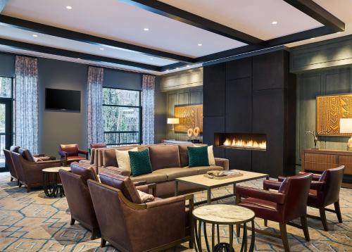 a living room with a couch and a table and chairs at Vail Residences at Cascade Village, a Destination by Hyatt Residence in Vail
