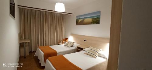 Ένα ή περισσότερα κρεβάτια σε δωμάτιο στο Hostal Rivas