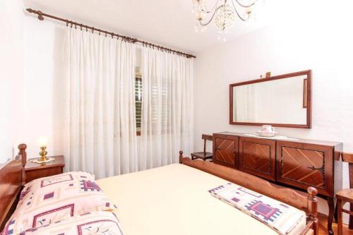 a bedroom with a bed and a mirror at Apartment in Slatine with Terrace, Air conditioning, WIFI, Washing machine (4784-3) in Slatine