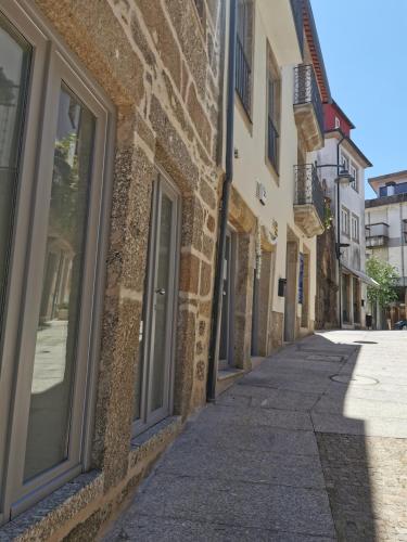 an empty street in a town with buildings at Apartamento Alto da Valeta in Arcos de Valdevez