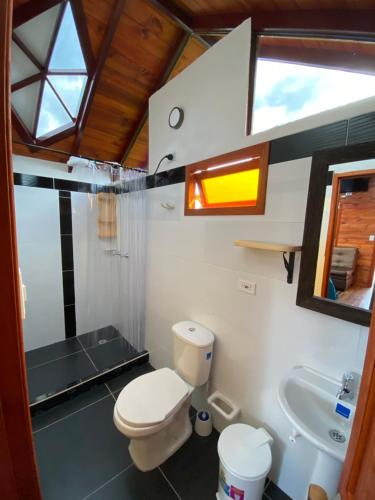 a bathroom with a toilet and a sink at GLAMPING VILLA PALVA en VILLA DE LEYVA in Villa de Leyva