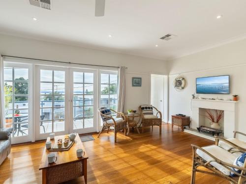 a living room with a couch and a fireplace at Mon Reve 4A Tallean Road three bedroom property with Wi-Fi, air conditioning in Nelson Bay