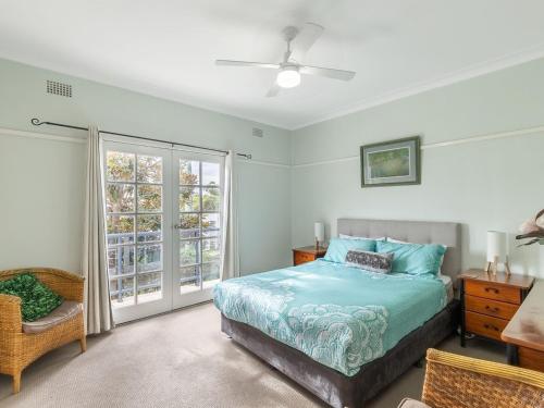 a bedroom with a bed and a window at Mon Reve 4A Tallean Road three bedroom property with air conditioning in Nelson Bay