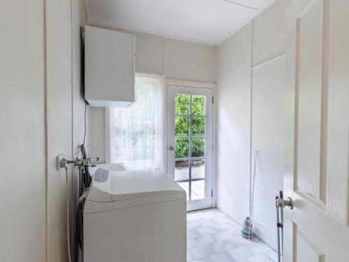 a white bathroom with a sink and a window at Mon Reve 4A Tallean Road three bedroom property with air conditioning in Nelson Bay