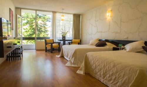 Postel nebo postele na pokoji v ubytování Gran Hotel Xalapa