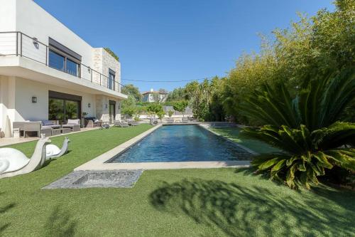 a swimming pool in the backyard of a house at SERRENDY Villa in Juan-Les-pins heated pool in Antibes