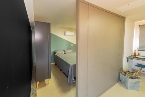 a bedroom with a bed in a room with a mirror at Jahu Center Plaza Flats in Jaú