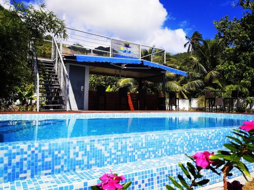 a swimming pool in front of a house at Lagoon Dream in Moorea