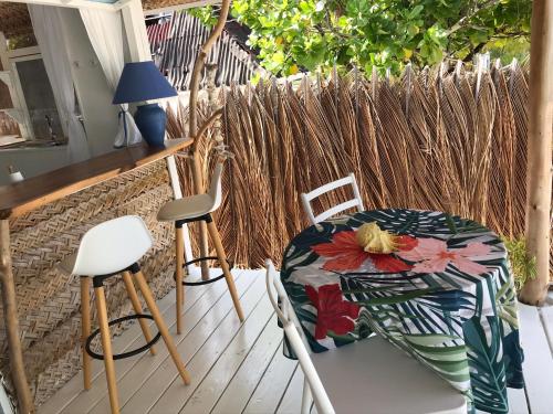 a patio with a table and chairs on a deck at Chez christiane in Tikehau