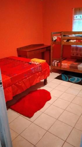 a bedroom with a bed and a red wall at Mack's Home in Clifton