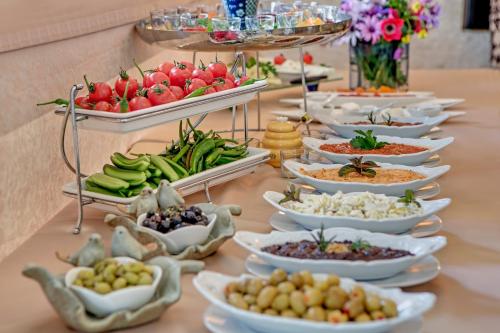 a buffet with many plates of food on a table at Bulbul Yuvası Boutique Hotel in Foca