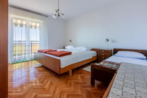 Postel nebo postele na pokoji v ubytování Apartments Mirena