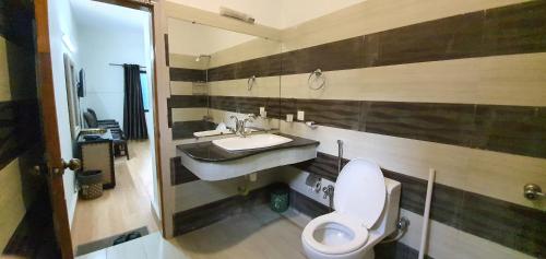 a bathroom with a toilet and a sink at Infinity Villa in Islamabad