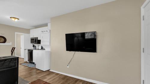 a white wall with a flat screen tv on a wall at Escape to Serenity in Colorado Springs