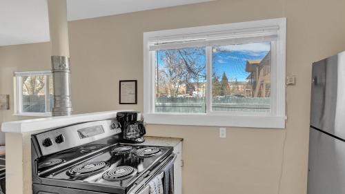 a kitchen with a stove and a window at Escape to Serenity in Colorado Springs