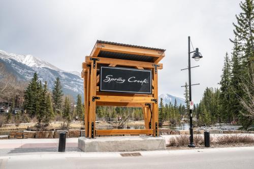 a sign on the side of a street at Spring Creek Spacious Luxury King One Bedroom plus Den at White Spruce Lodge in Canmore