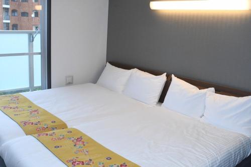 Krevet ili kreveti u jedinici u okviru objekta Hotel Urbansea 2 Matsuo
