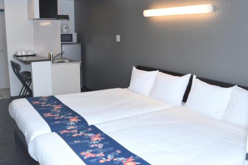 Krevet ili kreveti u jedinici u okviru objekta Hotel Urbansea 2 Matsuo