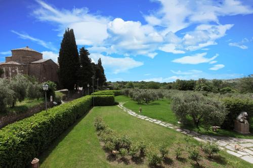 a view of a garden with bushes and trees at Sovana Hotel & Resort in Sovana