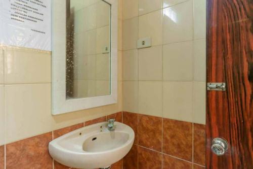a bathroom with a sink and a mirror at RedDoorz at Dwipa Wisata Hotel Lampung in Lampung