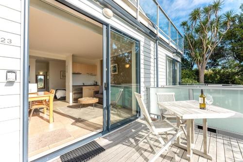 a sliding glass door leading to a patio with a table and chairs at Villa Sapphire at Palm Beach in Palm Beach