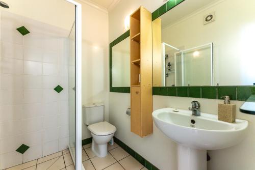 a bathroom with a sink and a toilet at Villa Haven - Waiheke Escapes in Palm Beach