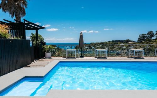 a swimming pool with a view of the ocean at Villa Sapphire at Palm Beach in Palm Beach