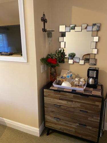 a wooden dresser in a room with a mirror at Ocean Breeze Executive Bed and Breakfast in North Vancouver