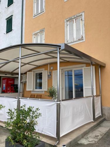 an open garage with white doors in front of a building at Apartment Lanterna in Piran