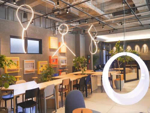 a restaurant with tables and chairs and lights at Hotel The M's Kyoto in Kyoto