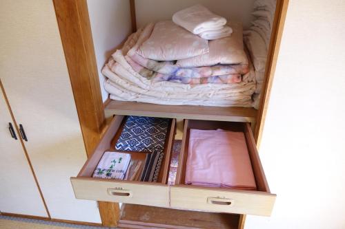 a wooden cabinet with a bed in it at ペンション桜家 in Shimoda