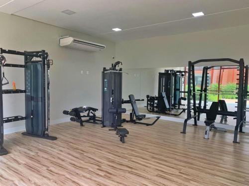a gym with several tread machines in a room at Resort Île de Pipa Flat in Pipa