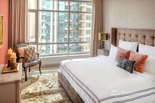 a bedroom with a bed and a large window at Dream Inn Apartments - Park Island in Dubai