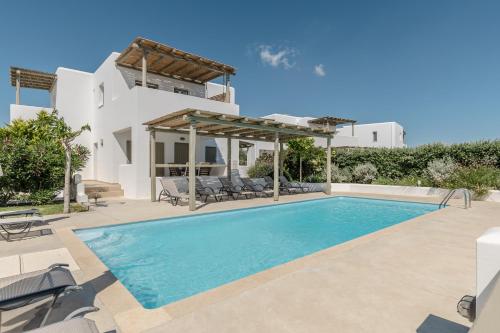 a villa with a swimming pool and a house at Sea & Olives Suites Hotel and Villas in Plaka