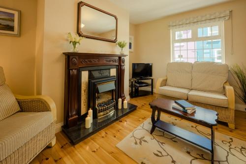 a living room with a fireplace and a couch at Seaview Heights in Dingle