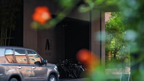 a car parked in front of a building with bikes at The Nook Hotel Hangzhou - A design hotel, 20 mins to West Lake and Lingyin Temple in Hangzhou