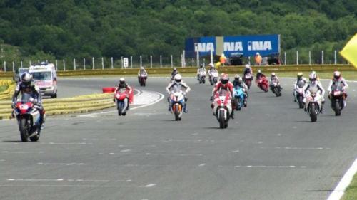 a group of people riding motorcycles on a road at Apartman Lusi in Buzdohanj