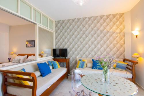 a hotel room with a couch and a table at Bellevue Suites in Agios Nikolaos