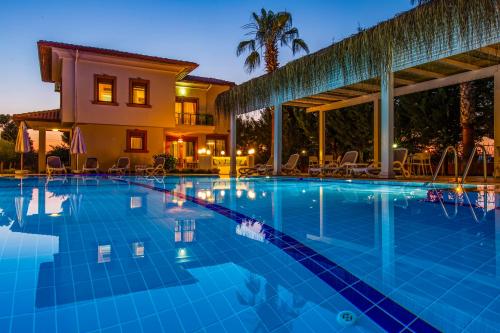 a swimming pool in front of a villa at VISTA Villa in Belek