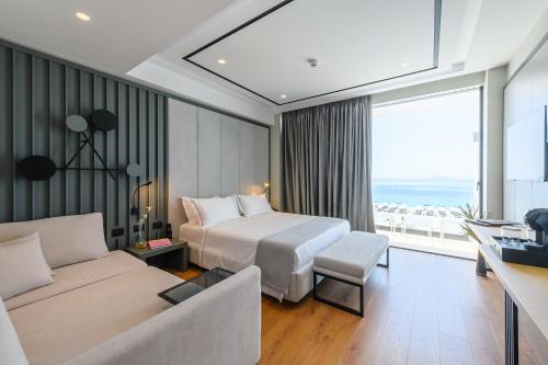 a hotel room with a bed and a couch at Miamar Luxury Hotel & Spa in Himare