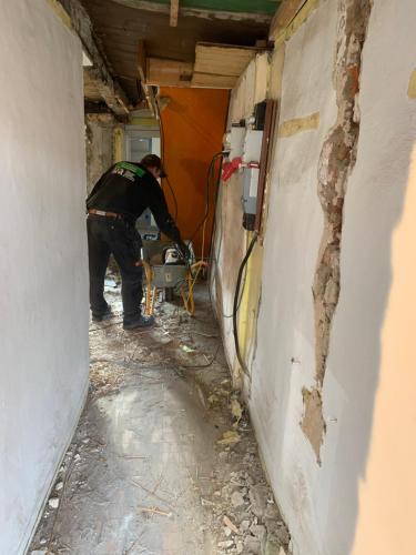 a man is working on a wall in a room at Præstegade 11 in Ribe