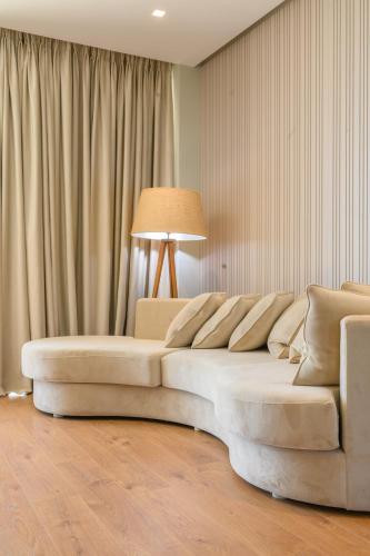 a living room with a couch and a lamp at Miamar Luxury Hotel & Spa in Himare