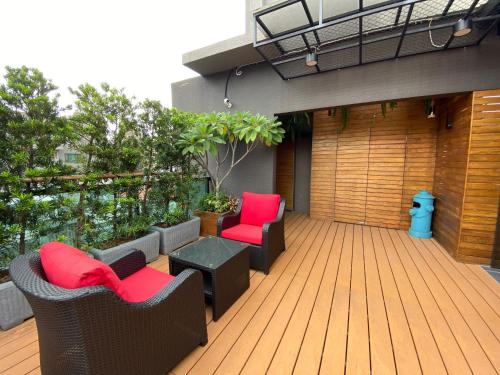 a deck with chairs and a table on a building at Royal Rose Hotel Xinsheng in Taipei