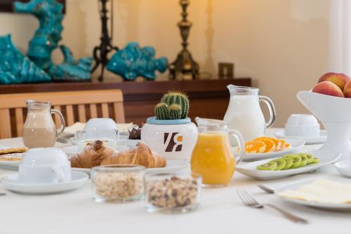 a table topped with plates of food and drinks at Hotel Villa Rita in Paestum