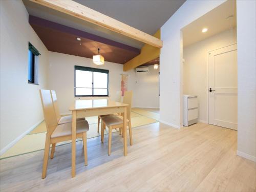a dining room with a wooden table and chairs at COTO Tokyo Asakusa 4 in Tokyo