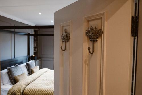 a bedroom with two beds and a wall at Kilmore Guesthouse in Kilkenny