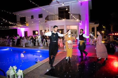 a group of people dancing by a pool at a wedding at Larnaca Mansion Ideal for 3 Families or more in Larnaka